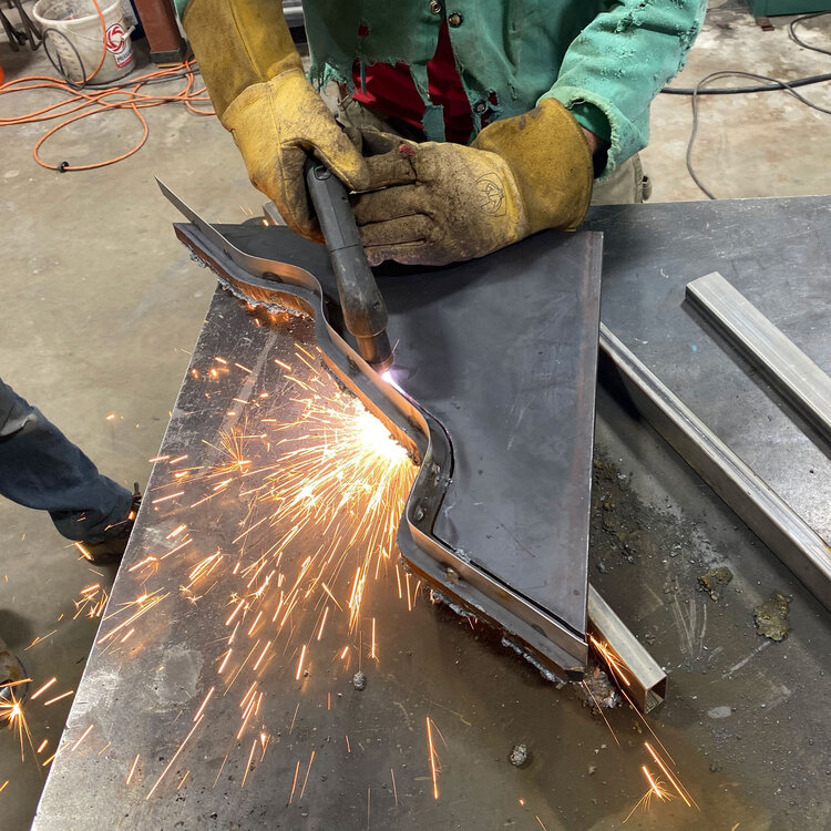 Brett started with a piece of 3/4” inch steel plate and a plasma torch. He had made a guide and could just ride the torch along for a perfect cut.